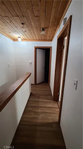 a kitchen with stainless steel appliances granite countertop a refrigerator a sink a stove and a wooden floors