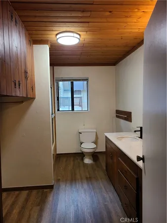 a bathroom with a sink a toilet and mirror