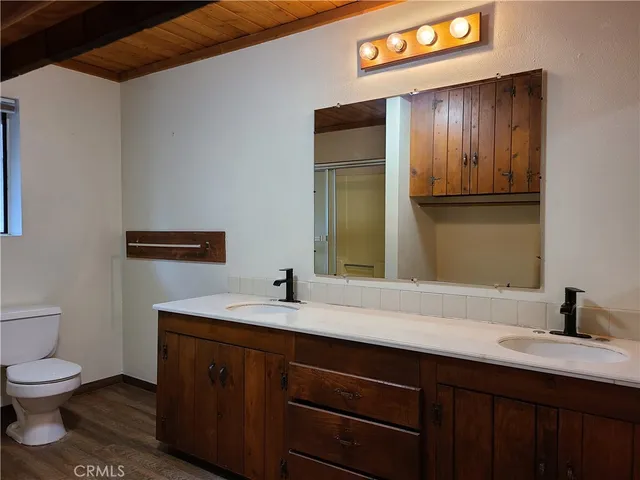 a room with a wooden floor and a bathroom
