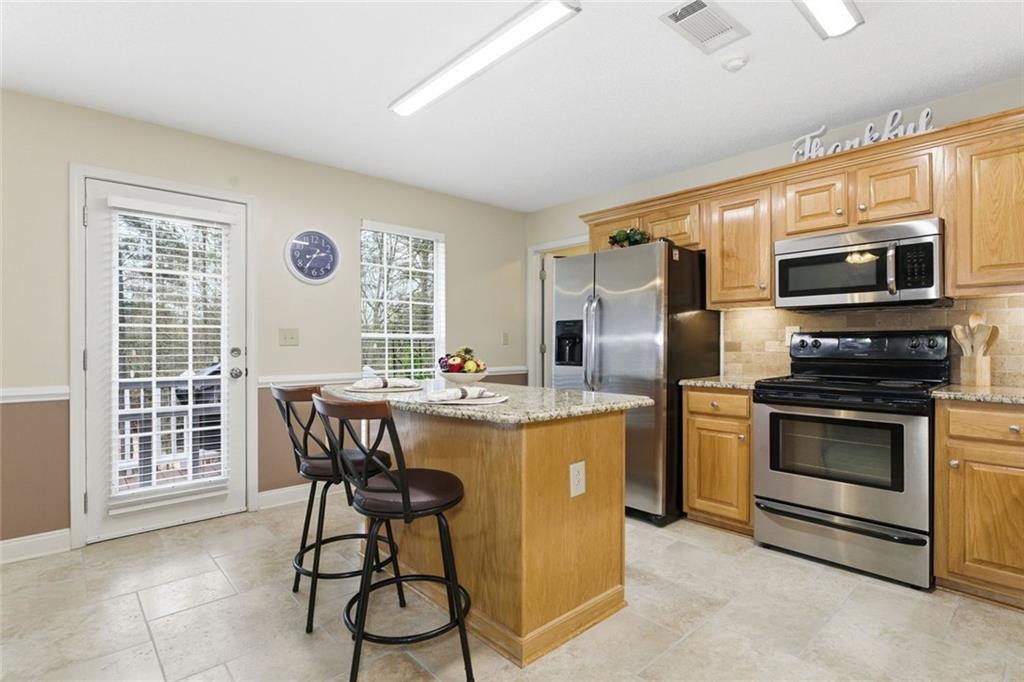 34 Rock Hole Path Dallas, GA 30132 - Photo 13 of 41 a kitchen with stainless steel appliances granite countertop a stove and a refrigerator