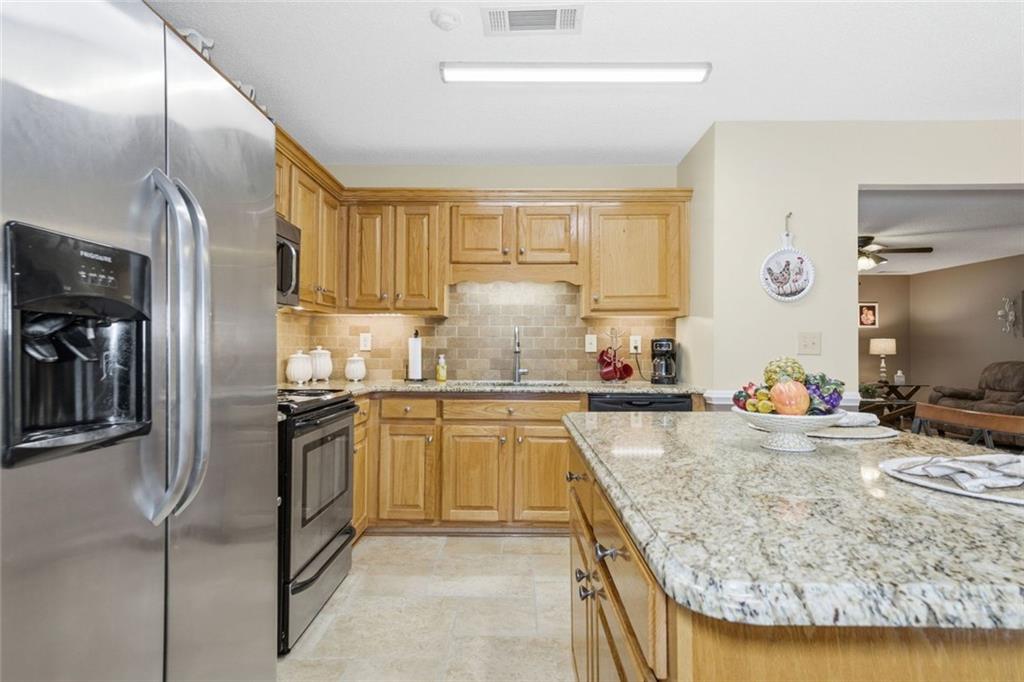 34 Rock Hole Path Dallas, GA 30132 - Photo 15 of 41 a kitchen with stainless steel appliances granite countertop a sink stove and refrigerator