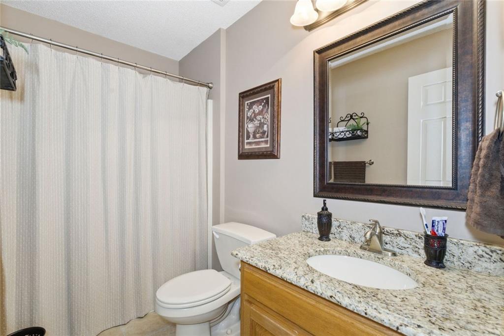 34 Rock Hole Path Dallas, GA 30132 - Photo 18 of 41 a bathroom with a granite countertop sink a toilet and a mirror