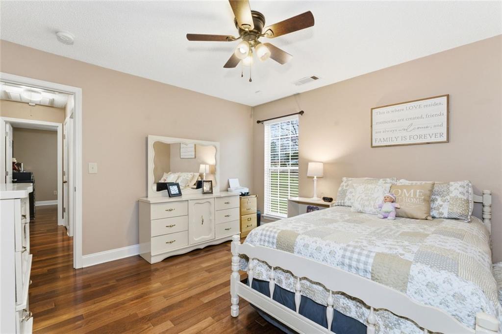 34 Rock Hole Path Dallas, GA 30132 - Photo 21 of 41 a bedroom with a bed and a chandelier fan