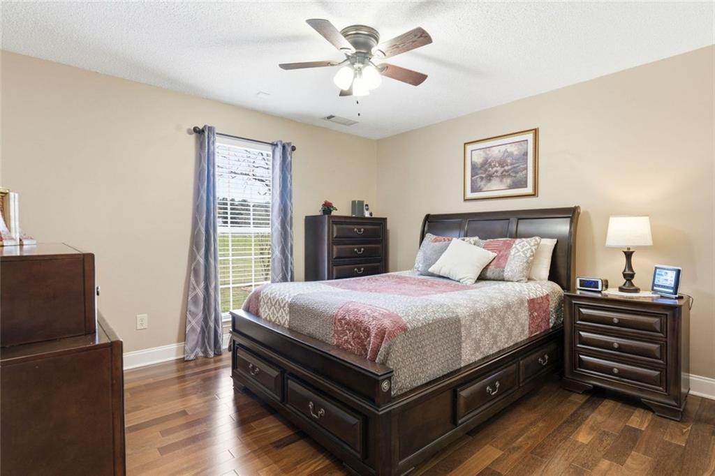 34 Rock Hole Path Dallas, GA 30132 - Photo 22 of 41 a bedroom with bed and wooden floor
