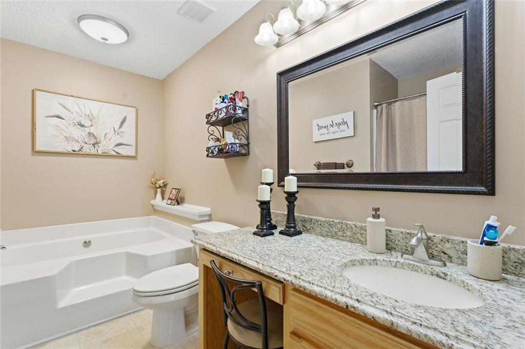 34 Rock Hole Path Dallas, GA 30132 - Photo 28 of 41 a bathroom with a granite countertop sink mirror vanity and toilet