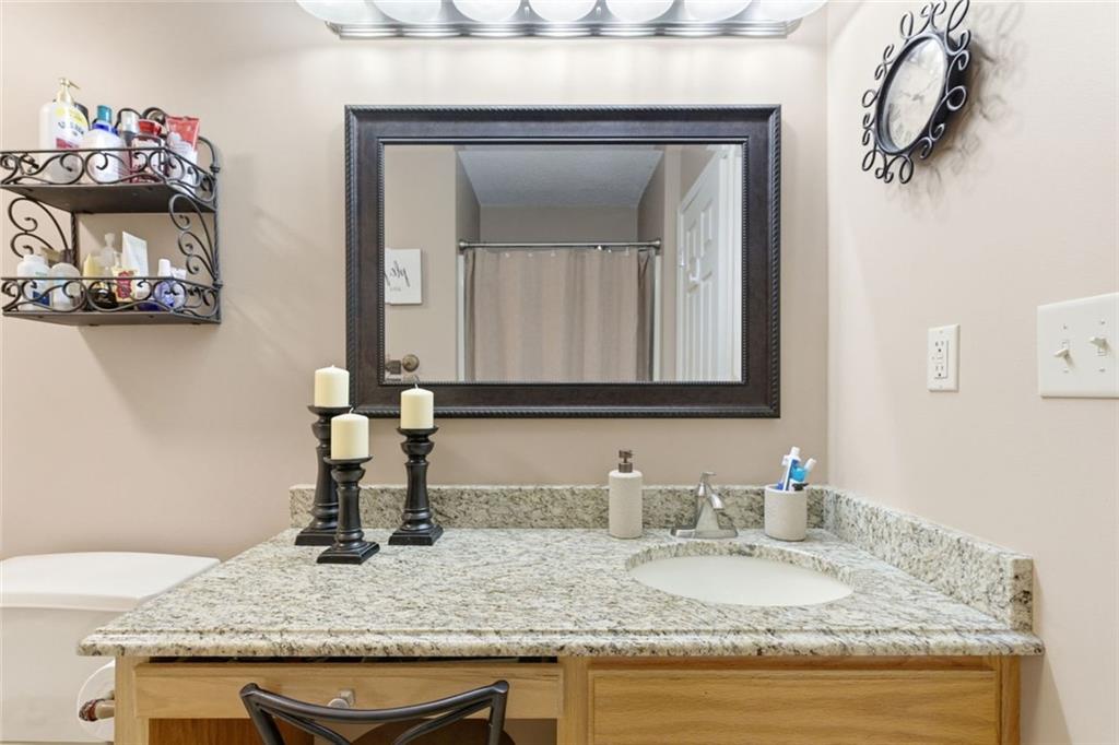 34 Rock Hole Path Dallas, GA 30132 - Photo 29 of 41 a bathroom with a granite countertop sink and a mirror