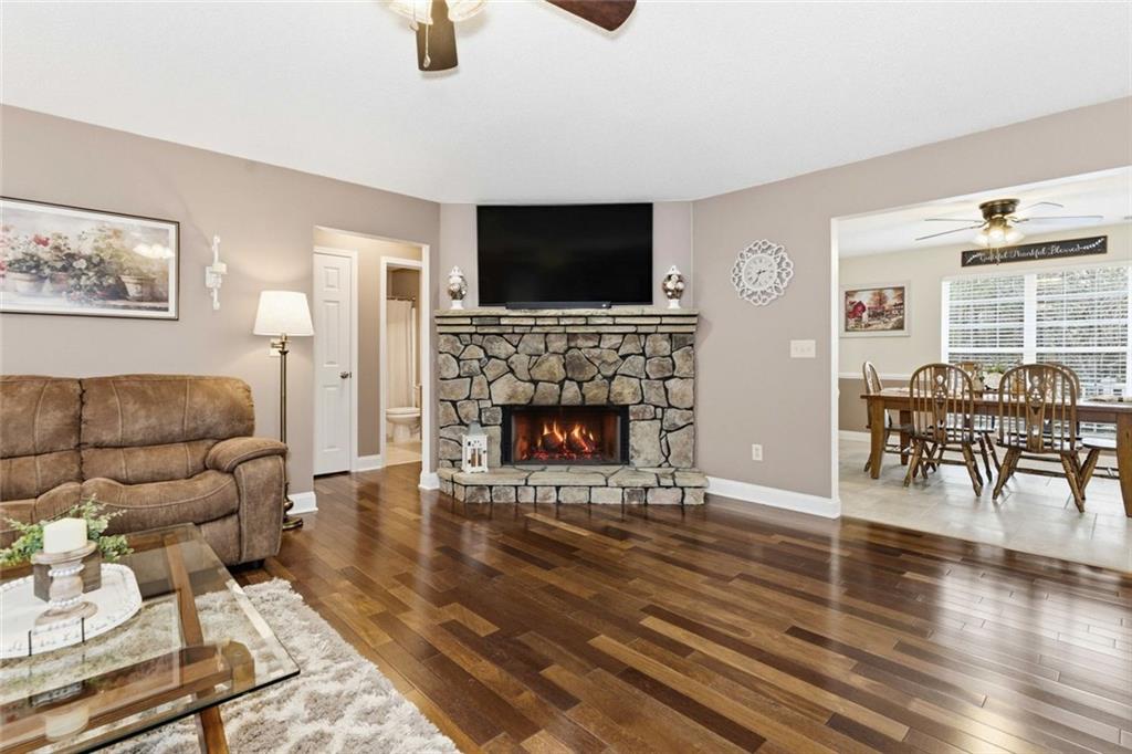 34 Rock Hole Path Dallas, GA 30132 - Photo 6 of 41 a living room with furniture a flat screen tv and a fireplace