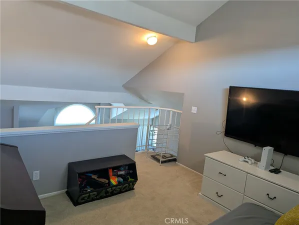 a living room with a couch and a potted plant