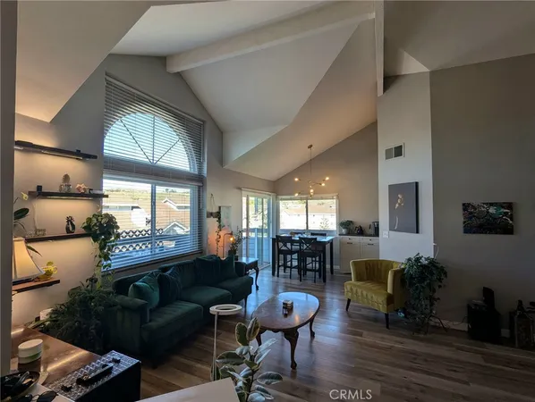 a living room with furniture fireplace and a large window
