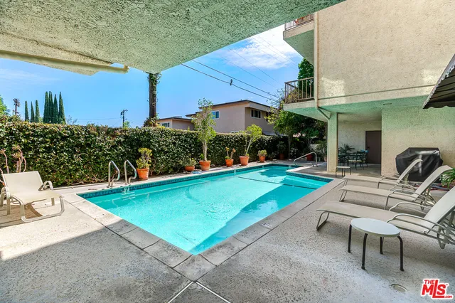 a view of a patio with chairs and a table