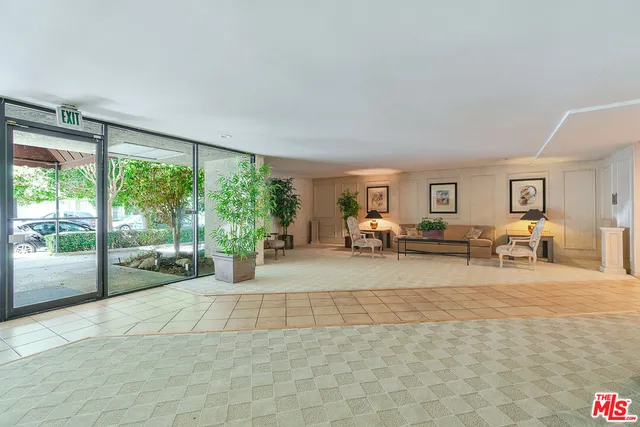 a living room with furniture and large windows