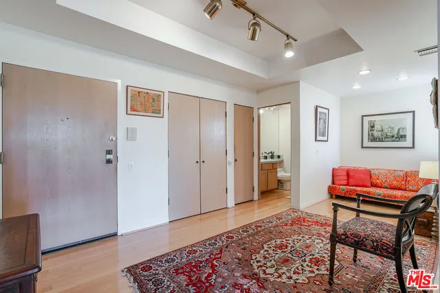 a furnished livingroom with a workspace