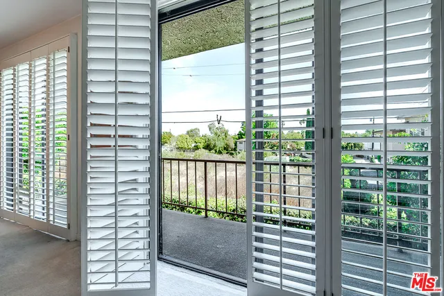 a view of a room that has a floor to ceiling window and an outdoor view