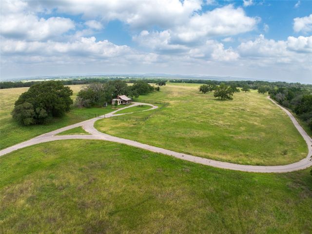 a view of field with trees in the background
