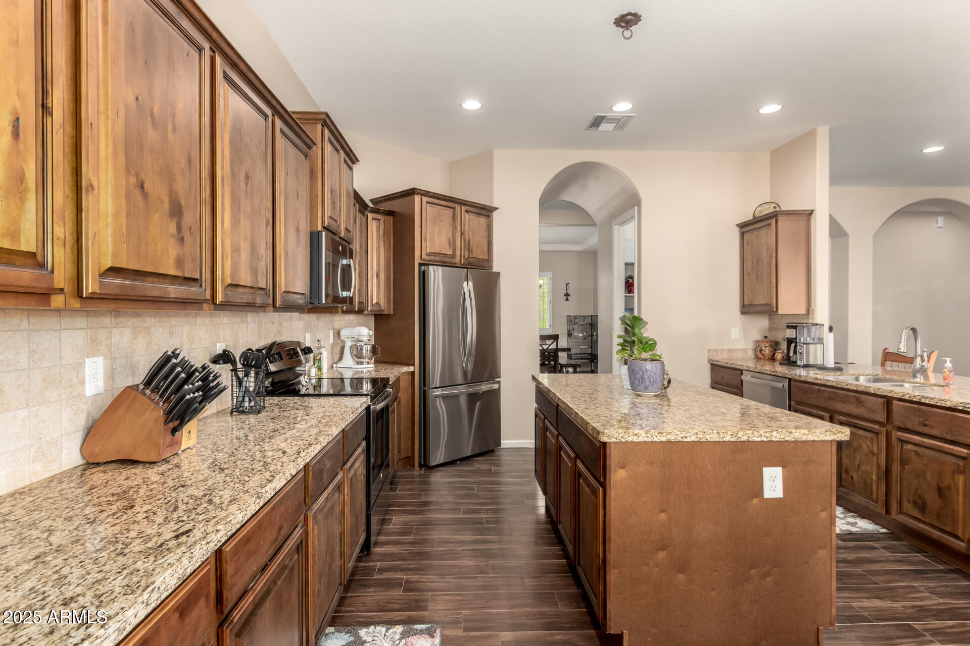 3614 West Phillips Road San Tan Valley, AZ 85144 - Photo 11 of 67 a kitchen with stainless steel appliances granite countertop a sink a stove and a refrigerator