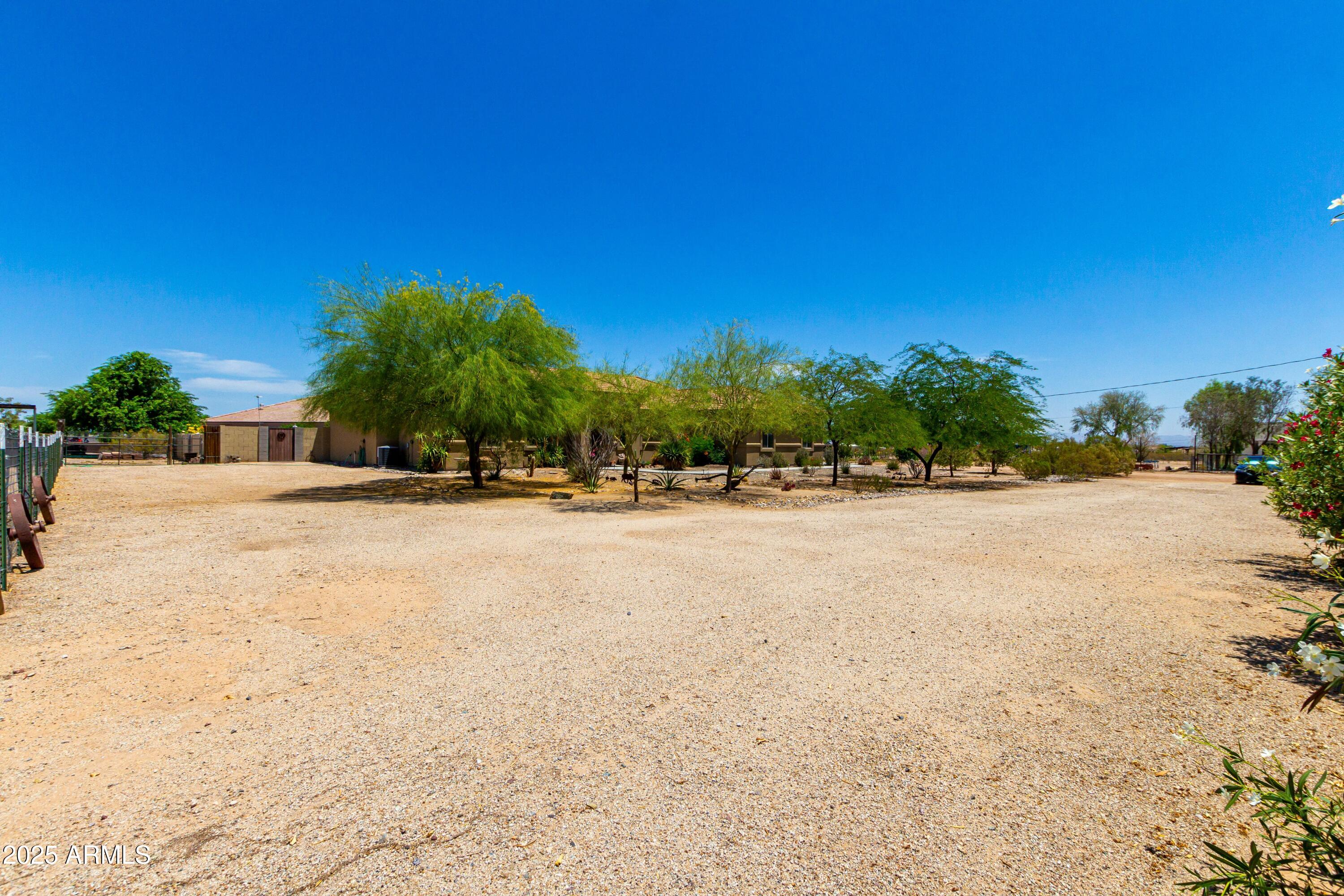 3614 West Phillips Road San Tan Valley, AZ 85144 - Photo 34 of 67 a view of swimming pool with outdoor seating and trees in the background