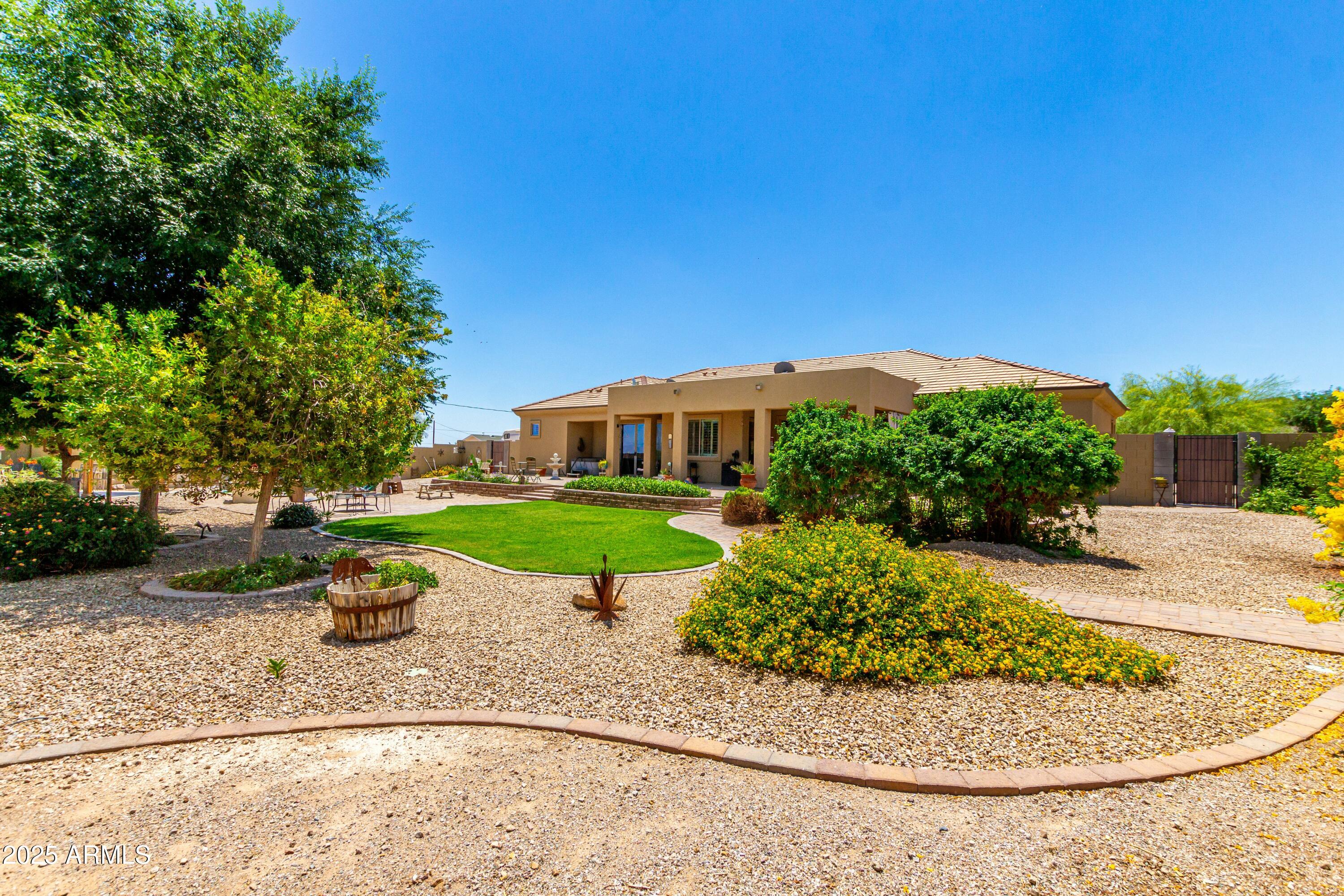 3614 West Phillips Road San Tan Valley, AZ 85144 - Photo 50 of 67 a view of a house with a yard and potted plants