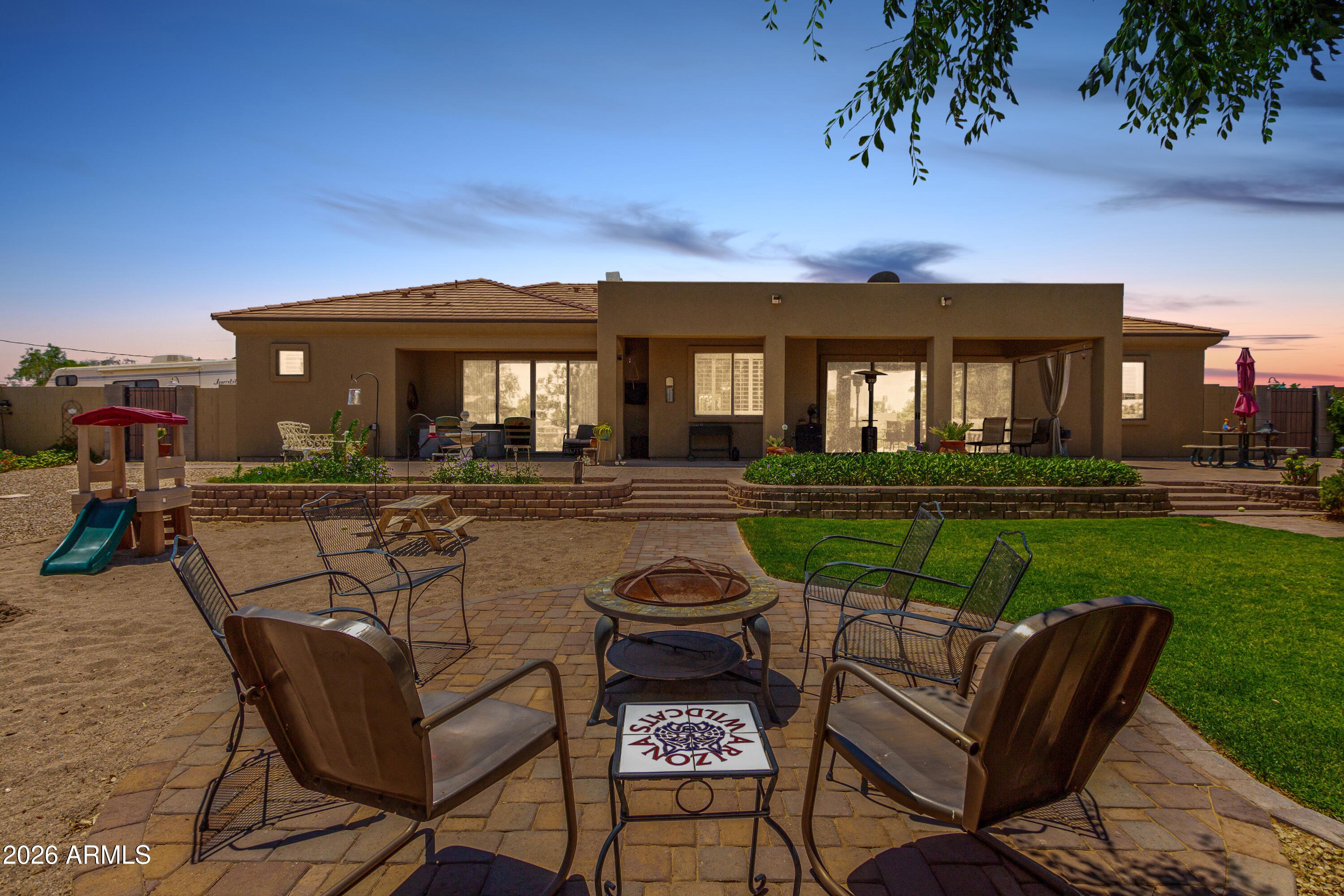 3614 West Phillips Road San Tan Valley, AZ 85144 - Photo 52 of 67 a view of a patio with couches table and chairs with plants and wooden fence