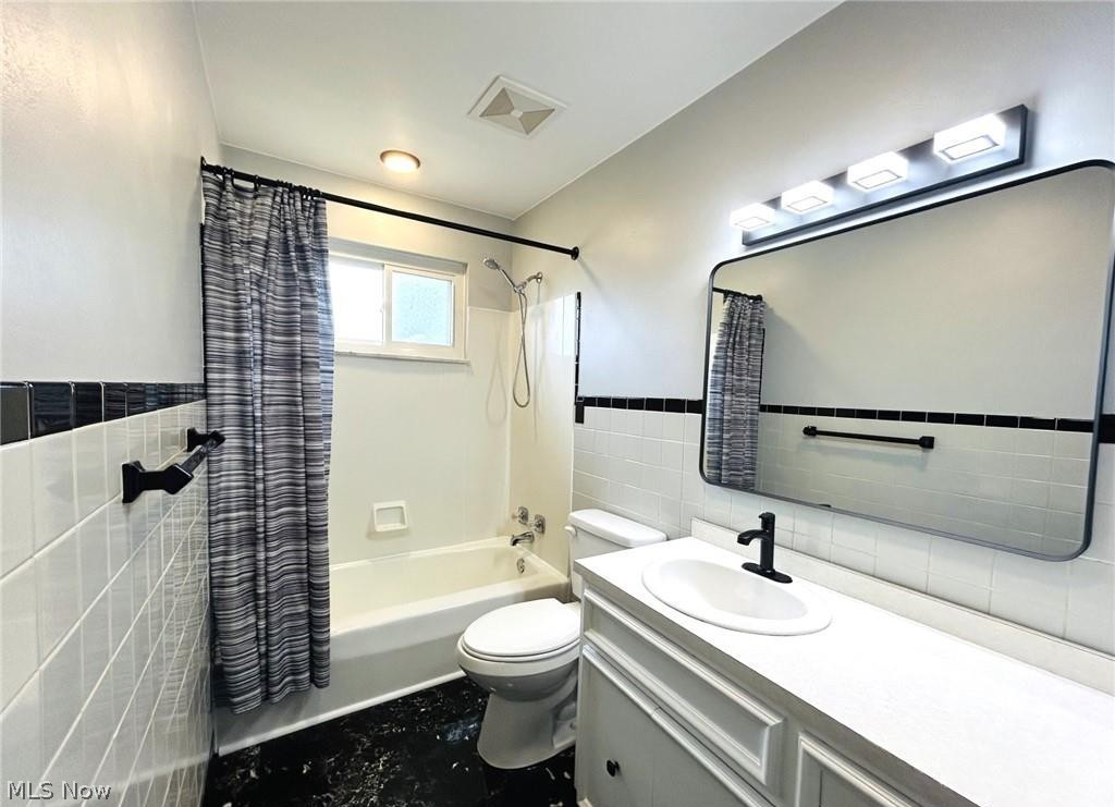 424 Lee Road Follansbee, WV 26037 - Photo 9 of 12 Bathroom with a toilet, vanity, and shower / bathtub combination with curtain