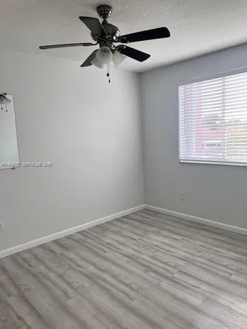 a bath tub sitting next to a white sink and vanity