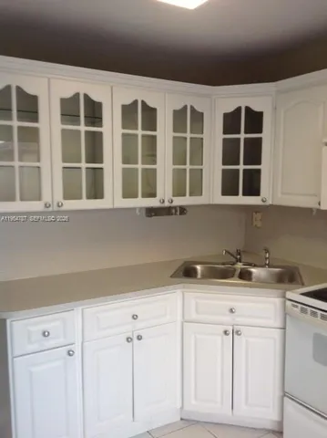 a kitchen with a sink and cabinets