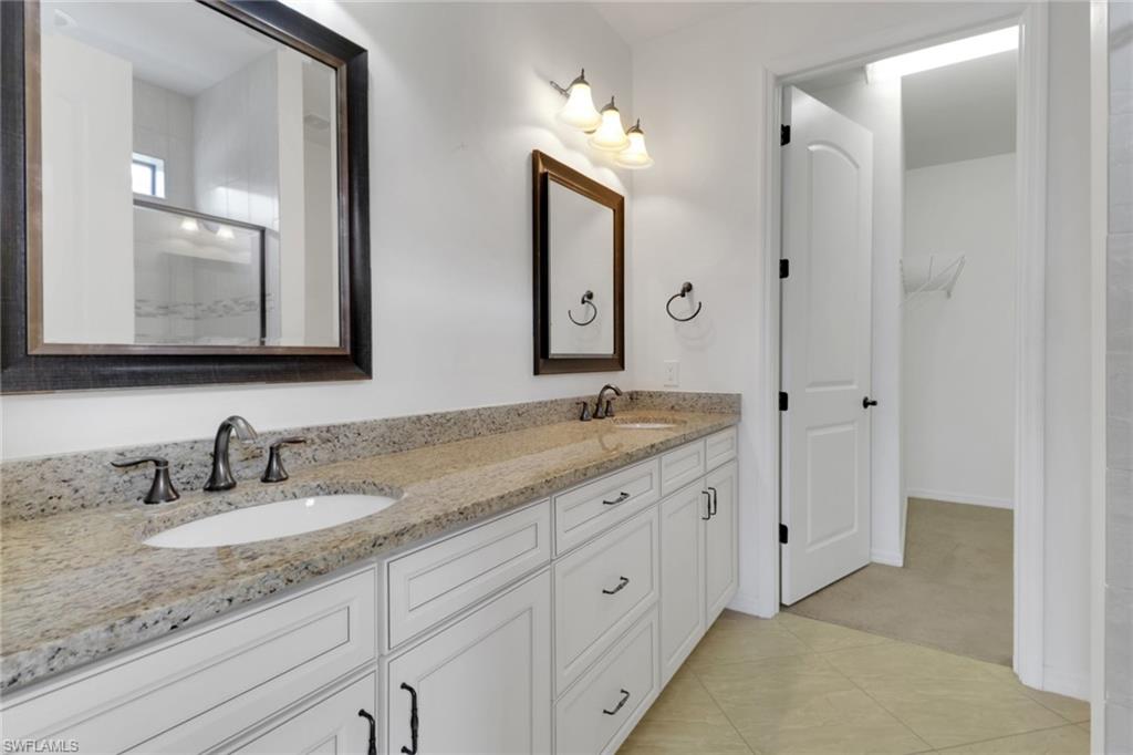 20281 Corkscrew Shores Boulevard Estero, FL 33928 - Photo 12 of 40 a bathroom with double sink and a mirror