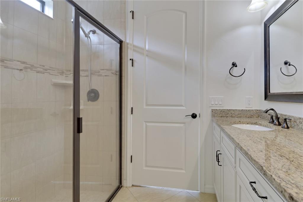 20281 Corkscrew Shores Boulevard Estero, FL 33928 - Photo 13 of 40 a bathroom with a granite countertop shower sink and mirror