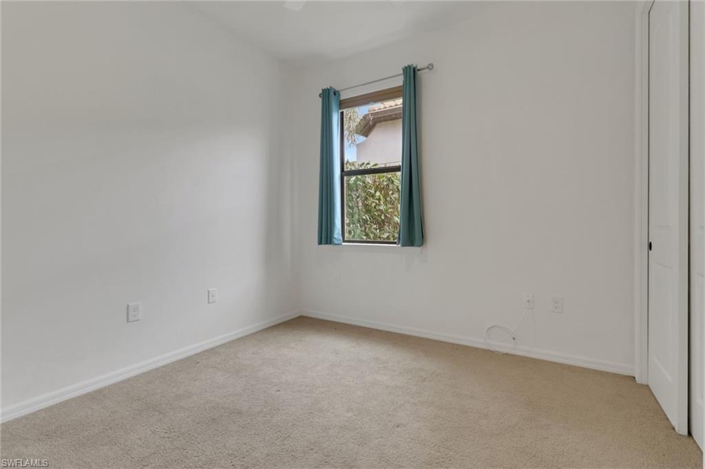 20281 Corkscrew Shores Boulevard Estero, FL 33928 - Photo 14 of 40 an empty room with windows and closet