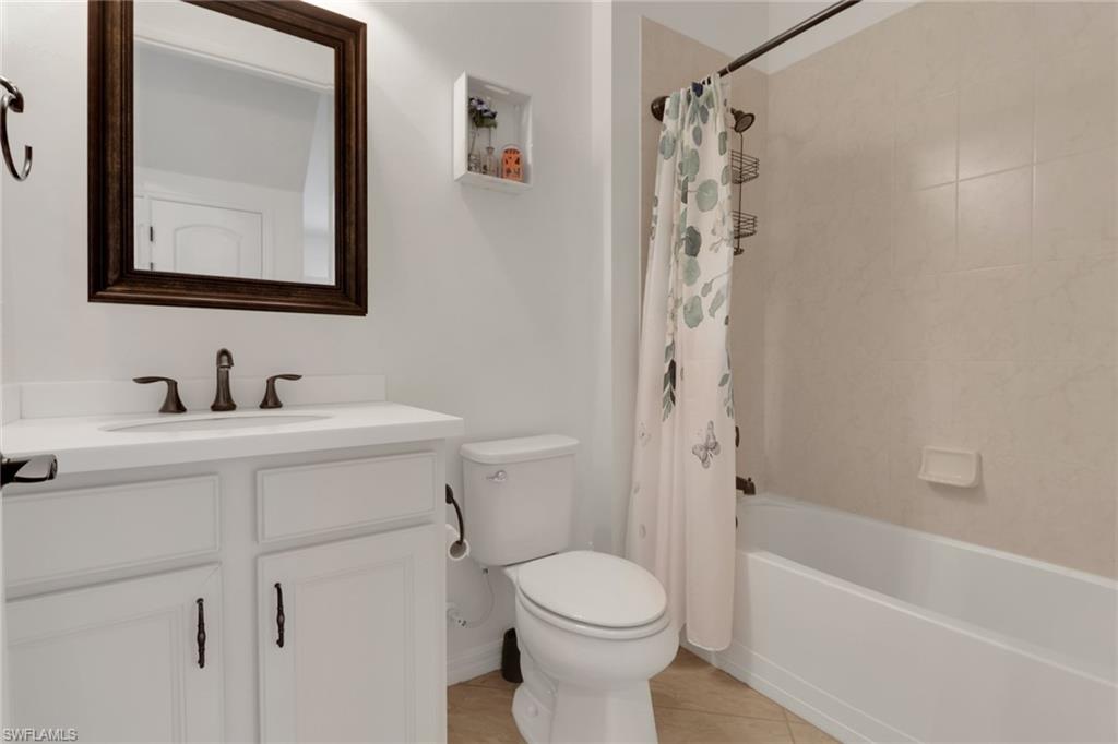 20281 Corkscrew Shores Boulevard Estero, FL 33928 - Photo 16 of 40 a bathroom with a sink toilet and shower