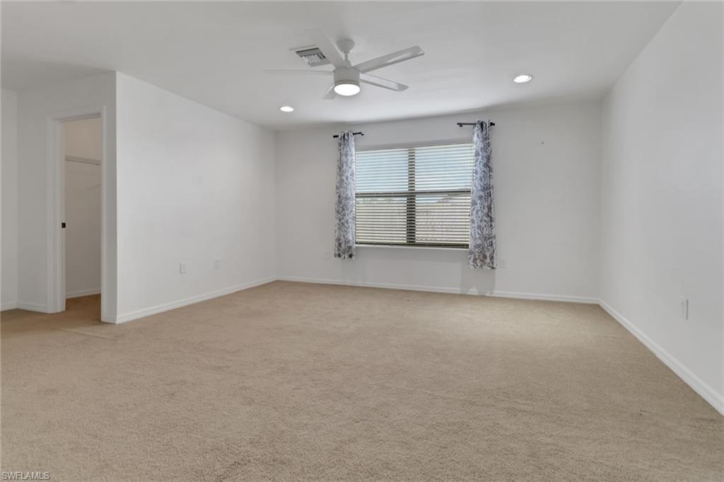 20281 Corkscrew Shores Boulevard Estero, FL 33928 - Photo 20 of 40 an empty room with a ceiling fan and window