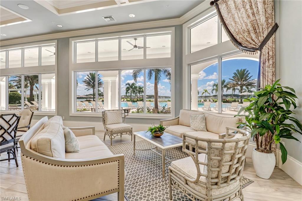 20281 Corkscrew Shores Boulevard Estero, FL 33928 - Photo 32 of 40 a living room with furniture a chandelier and a large window