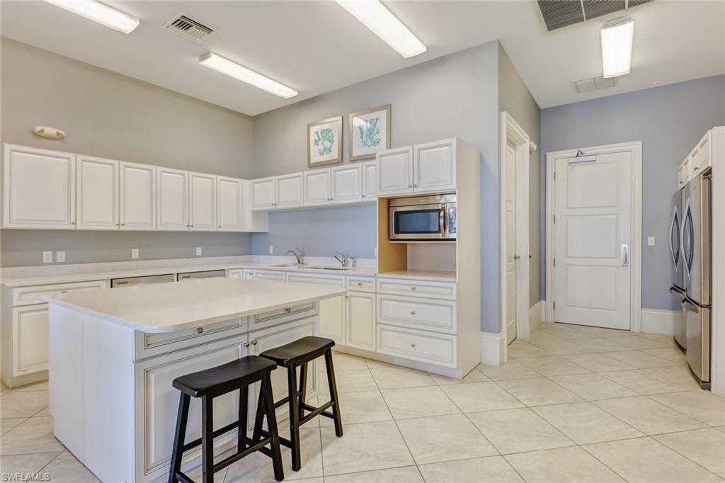 20281 Corkscrew Shores Boulevard Estero, FL 33928 - Photo 33 of 40 a kitchen with a stove a sink and a refrigerator