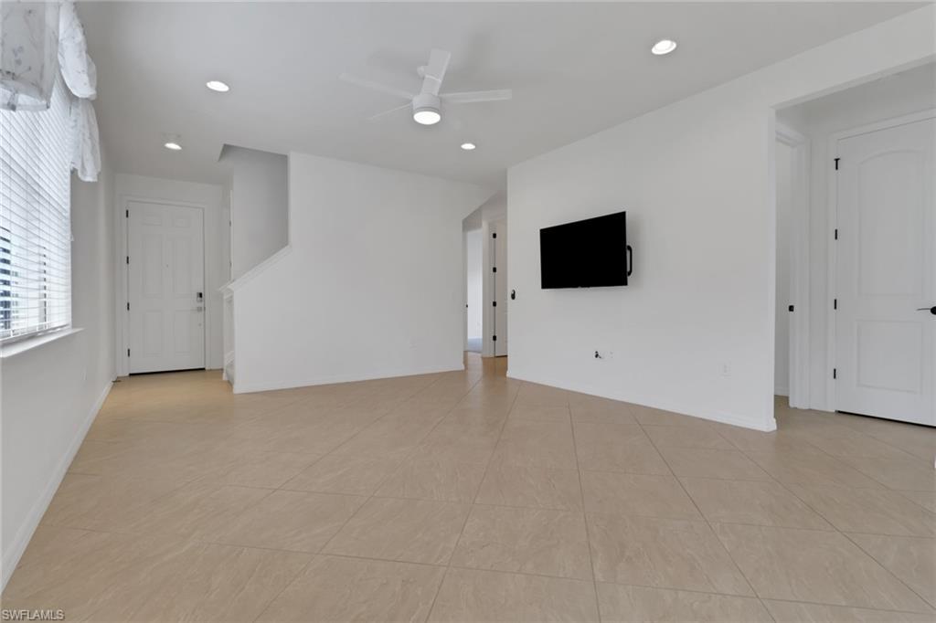 20281 Corkscrew Shores Boulevard Estero, FL 33928 - Photo 4 of 40 an empty room with windows and fireplace