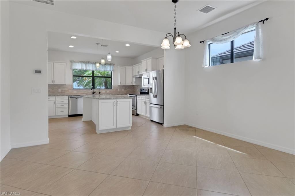 20281 Corkscrew Shores Boulevard Estero, FL 33928 - Photo 7 of 40 a view of a kitchen with refrigerator and windows