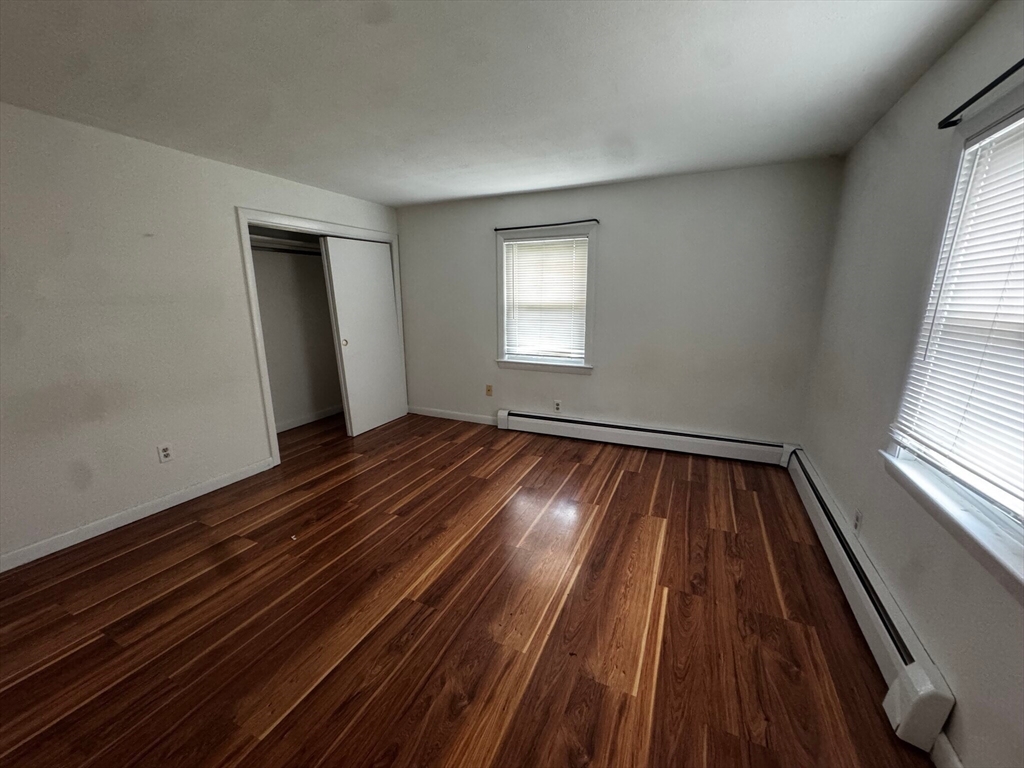 87 R Madison Street, Unit 2R Malden, MA 02148 - Photo 4 of 8 wooden floor in an empty room with a window
