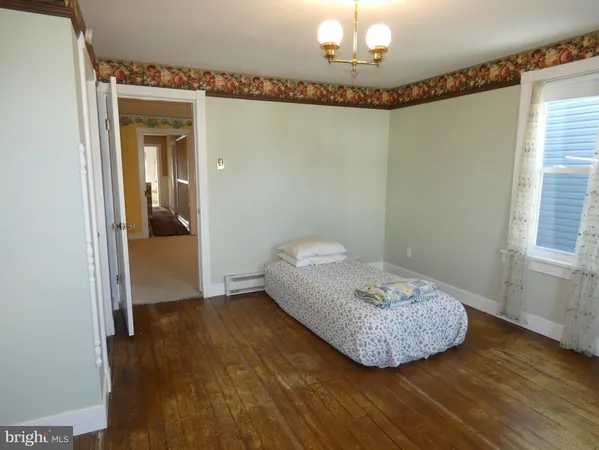 a view of a room with wooden floor and chair