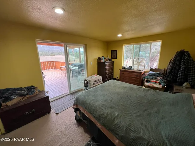 a bed room with a bed and a chair