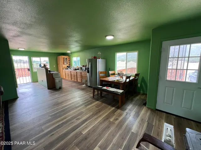 a living room with furniture and wooden floors