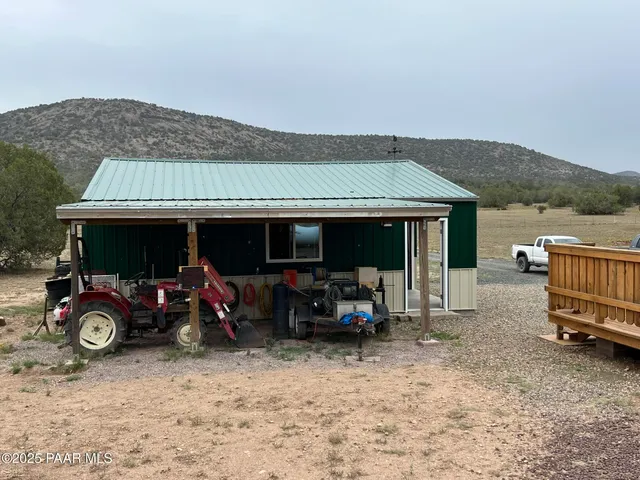 a view of house with backyard and furniture