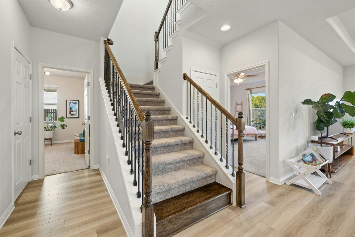 436 Staunton Drive Leander, TX 78641 - Photo 17 of 39 a view of a hallway with wooden floor and stairs