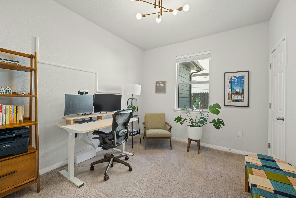 436 Staunton Drive Leander, TX 78641 - Photo 18 of 39 Office space featuring an inviting chandelier, baseboards, and light colored carpet