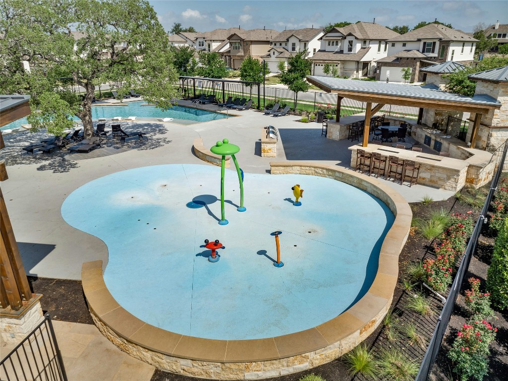 436 Staunton Drive Leander, TX 78641 - Photo 35 of 39 Community pool featuring a patio, a residential view, outdoor dry bar, fence, and a water play area