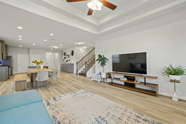 a kitchen with a refrigerator a dining table and chairs