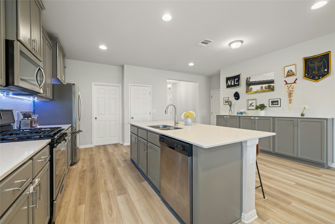 436 Staunton Drive Leander, TX 78641 - Photo 9 of 39 a kitchen with stainless steel appliances granite countertop a sink stove and refrigerator
