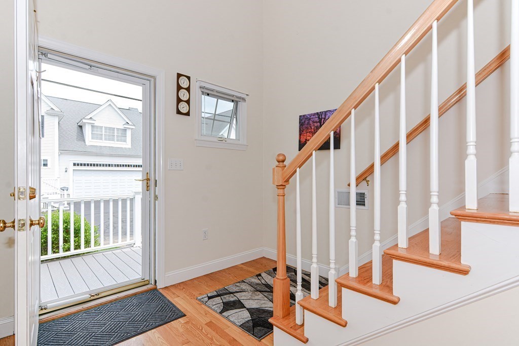 237 Pleasant Street, Unit 237 Norwood, MA 02062 - Photo 15 of 40 a view of an entryway with wooden floor and door