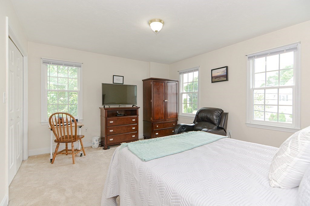 237 Pleasant Street, Unit 237 Norwood, MA 02062 - Photo 18 of 40 a bedroom with a bed and furniture