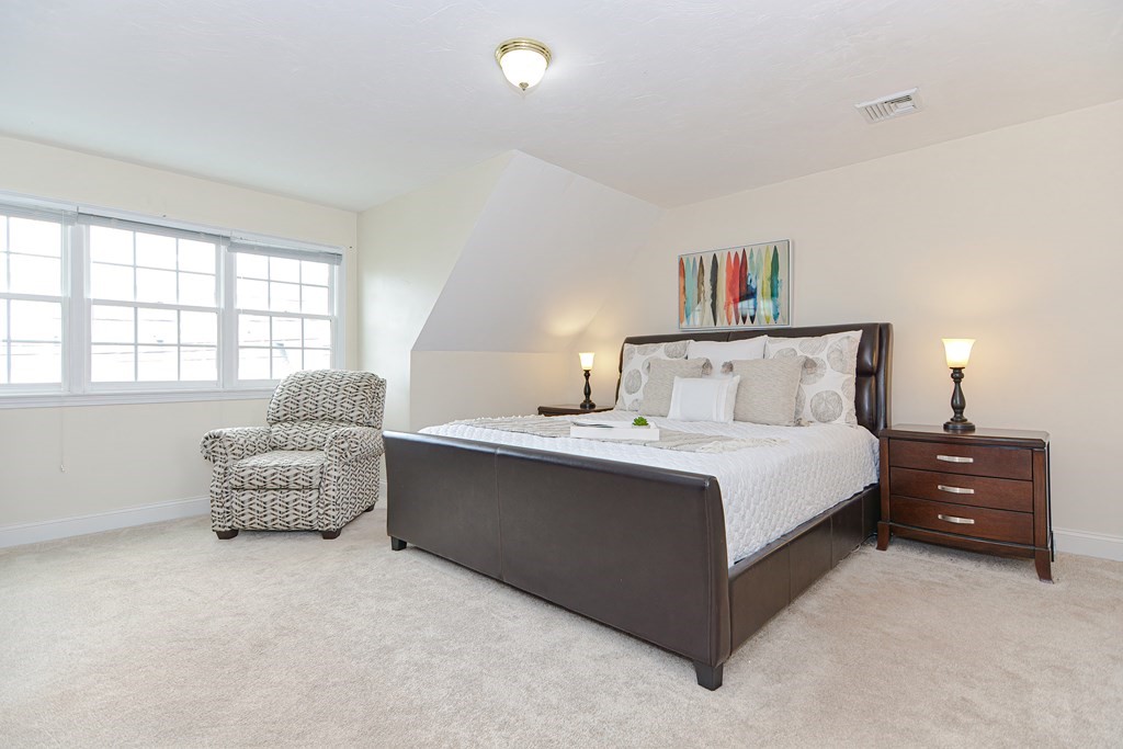 237 Pleasant Street, Unit 237 Norwood, MA 02062 - Photo 24 of 40 a bedroom with a bed and a couch
