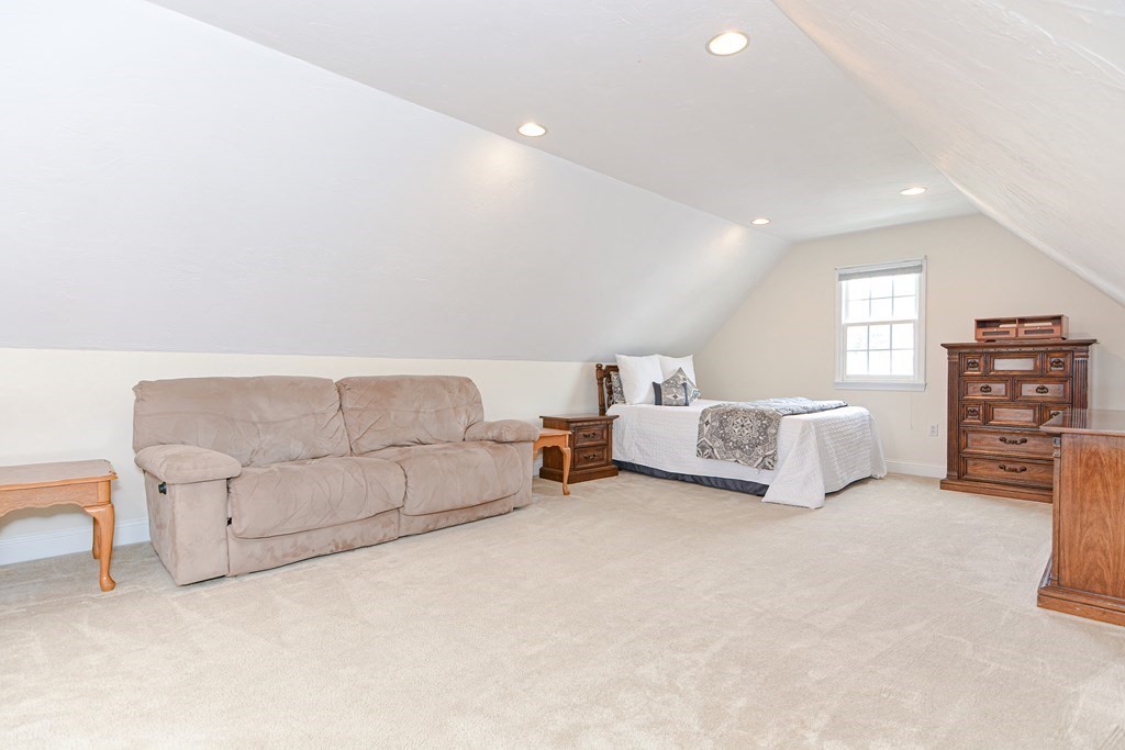 237 Pleasant Street, Unit 237 Norwood, MA 02062 - Photo 33 of 40 a living room with furniture and a lamp