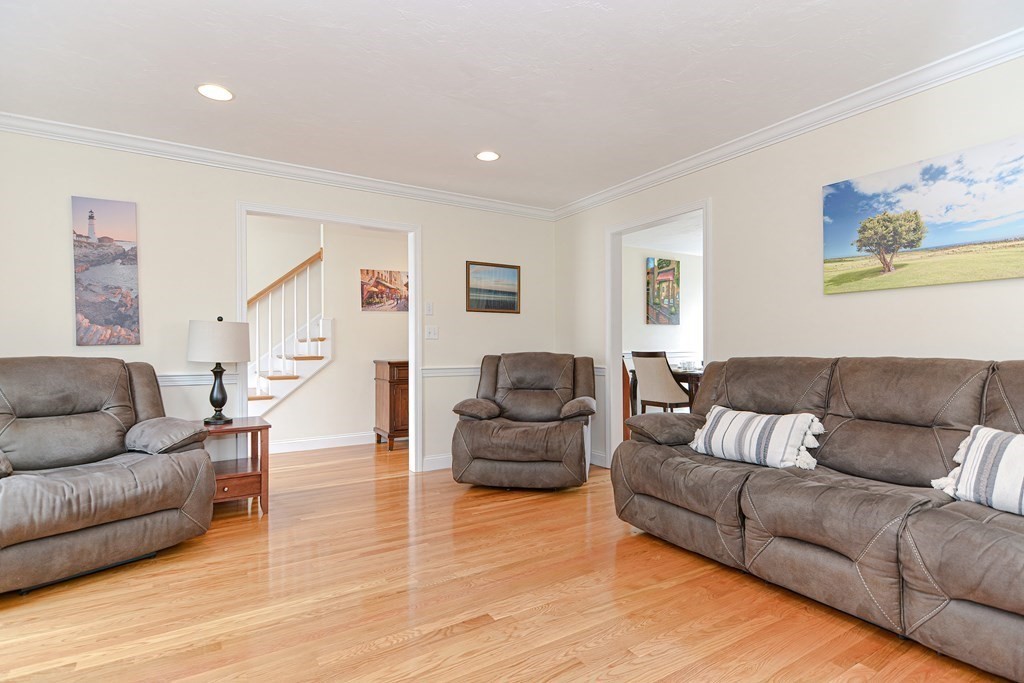 237 Pleasant Street, Unit 237 Norwood, MA 02062 - Photo 10 of 40 a living room with furniture and a wooden floor