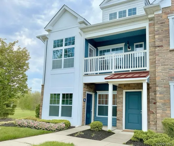 front view of a brick house with a yard
